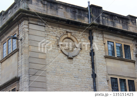 Oxford, United Kingdom - Dec 22, 2025: The old brick building with a round stone plaque on its facade. Inscription on the building remembering the Pupil Teachers Centre. 135151425