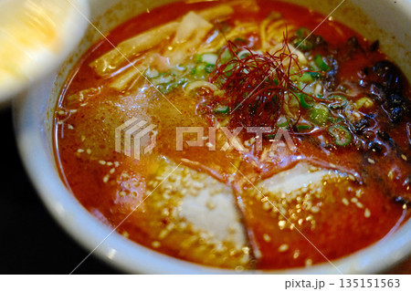 A delicious bowl of traditional Japanese ramen with pork, egg, noodles, and flavorful broth. 135151563