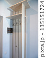 Minimal hallway wardrobe with wooden coat hooks 135151724