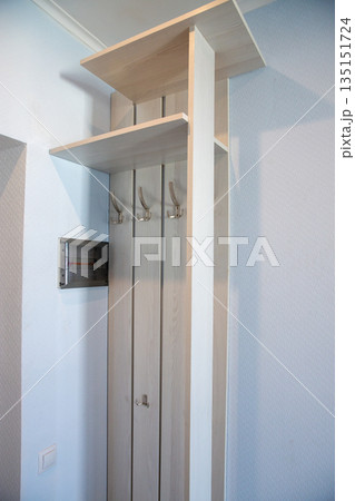 Minimal hallway wardrobe with wooden coat hooks Minimal hallway wardrobe with wooden coat hooks 135151724