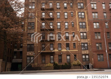 Facade of a classic brick apartment building in a city. 135152074