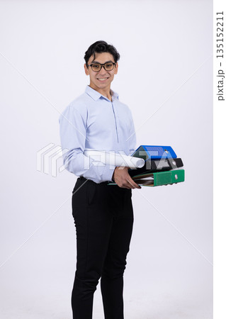 Businessman in a blue shirt holding office folders. Businessman in a blue shirt holding office folders. 135152211