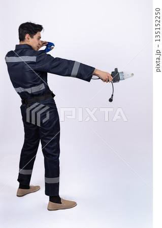 Professional worker in uniform checking a measuring tape. Professional worker in uniform checking a measuring tape. 135152250