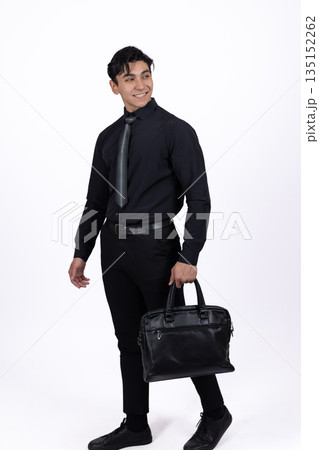 Man in a black suit holding a leather briefcase. Man in a black suit holding a leather briefcase. 135152262