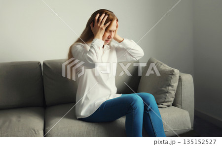 Exhausted tired woman suffering from headache, stress, fatigue, temples pain, migraine, loud noise 135152527