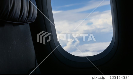 Scenery outside the window of a passenger plane, beautiful blue sky and white cloud view Scenery outside the window of a passenger plane, beautiful blue sky and white cloud view 135154584