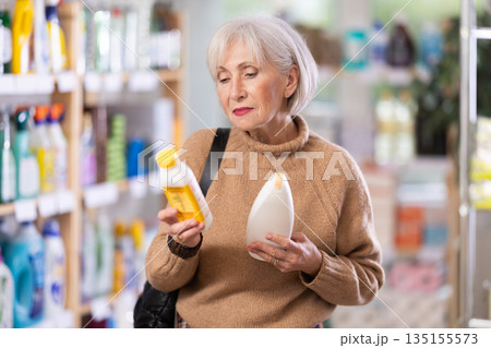 woman chooses hair care products woman chooses hair care products 135155573