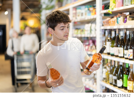 Guy choosing wine in the store 135155632