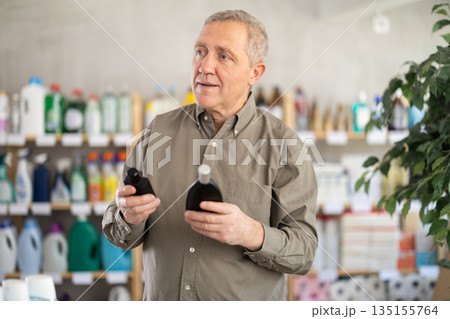 Elderly man choosing perfume in a European supermarket Elderly man choosing perfume in a European supermarket 135155764