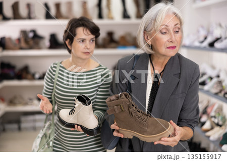 Two women are shopping in shoe store 135155917