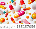 A vibrant array of capsules and pills floating against on white background, healthy concept 135157056