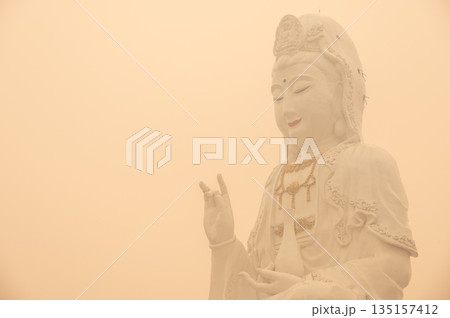 An iconic statue of Guanyin located in Wat Huay Pla Kang of Chiang Rai province of Thailand covered with bad air pollution (PM 2.5). PM2.5 levels meaning the air quality posed a health hazard. An iconic statue of Guanyin located in Wat Huay Pla Kang of Chiang Rai province of Thailand covered with bad air pollution (PM 2.5). PM2.5 levels meaning the air quality posed a health hazard. 135157412