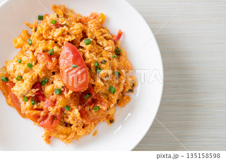 Stir-fried tomatoes with egg or Scrambled eggs with tomatoes 135158598