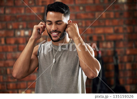 Fitness, earphones and music, man in gym listening to streaming service for motivation podcast and smile. Exercise, workout and happy bodybuilder, online radio or audio for healthy mindset in club. Fitness, earphones and music, man in gym listening to streaming service for motivation podcast and smile. Exercise, workout and happy bodybuilder, online radio or audio for healthy mindset in club. 135159326