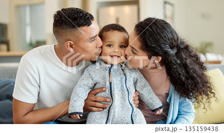 Family, kiss and portrait of baby in home living room, bonding and having fun in house. Father, mother and kissing face of newborn on sofa for love, care and affection, happiness and smile together. Family, kiss and portrait of baby in home living room, bonding and having fun in house. Father, mother and kissing face of newborn on sofa for love, care and affection, happiness and smile together. 135159438