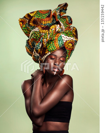 Beauty, black woman fashion and cosmetics with African head wrap and makeup in studio. Isolated, green background and young female person with a traditional hair scarf with confidence and culture 135159442