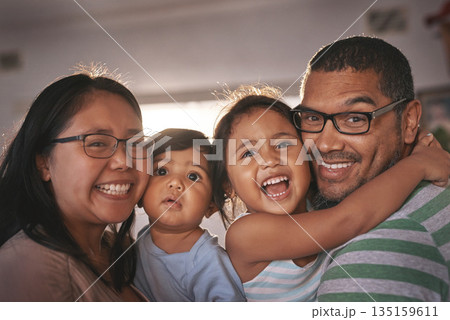 Portrait, laugh and happy family hug in a living room, excited and bonding in their home together. Face, children and parents in a lounge embrace, relax and laughing at funny, comedy and crazy joke Portrait, laugh and happy family hug in a living room, excited and bonding in their home together. Face, children and parents in a lounge embrace, relax and laughing at funny, comedy and crazy joke 135159611