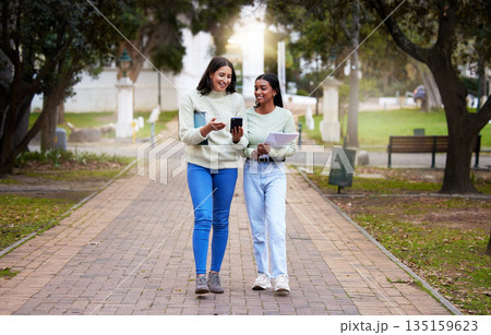 Happy, female students and friends with a smartphone walking together at university reading exam test results on a mobile app. Technology, smile and college girls on social media or chat on campus Happy, female students and friends with a smartphone walking together at university reading exam test results on a mobile app. Technology, smile and college girls on social media or chat on campus 135159623