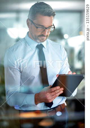 Typing email, app and a businessman with a tablet for communication, connection and internet. Digital, working and a mature employee reading information, agenda or schedule on technology in office 135159629