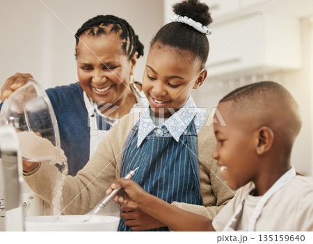 Family with smile, grandmother teaching kids baking and learning cooking skill in kitchen with help and support. Old woman with girl and boy, development with growth and bake with ingredients at home Family with smile, grandmother teaching kids baking and learning cooking skill in kitchen with help and support. Old woman with girl and boy, development with growth and bake with ingredients at home 135159640