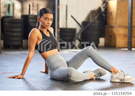 Portrait, fitness or Indian woman on break in gym relaxing ready for sports exercise, workout or wellness. Tired athlete, floor or healthy girl bodybuilder resting for recovery after exercising Portrait, fitness or Indian woman on break in gym relaxing ready for sports exercise, workout or wellness. Tired athlete, floor or healthy girl bodybuilder resting for recovery after exercising 135159704