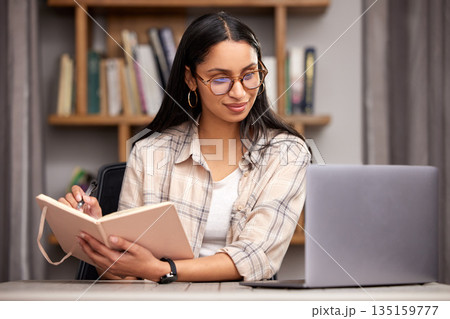 Laptop, notebook and learning with a student woman in a university library to study for a final exam. Technology, education and diary with a young female college pupil reading research material Laptop, notebook and learning with a student woman in a university library to study for a final exam. Technology, education and diary with a young female college pupil reading research material 135159777