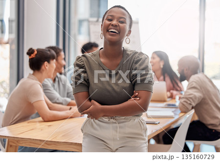Portrait, smile and black woman with arms crossed, startup success and teamwork in a modern office. Face, female person or leader with staff, manager or happiness with humor, meeting and professional 135160729