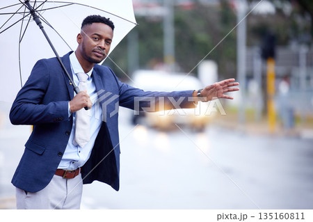 African business, man and transport with wave, taxi or bus in metro street with umbrella in winter rain. Black businessman, city and road for transportation, travel and stop with hand, sign or call African business, man and transport with wave, taxi or bus in metro street with umbrella in winter rain. Black businessman, city and road for transportation, travel and stop with hand, sign or call 135160811