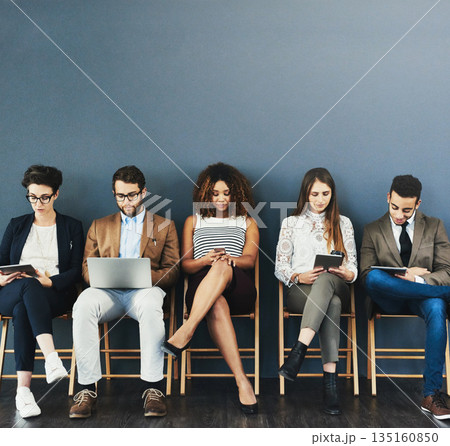Business people, hiring and busy before a job interview waiting room and sitting in line. Online communication, technology and staff with diversity and wall background for recruit meeting with mockup Business people, hiring and busy before a job interview waiting room and sitting in line. Online communication, technology and staff with diversity and wall background for recruit meeting with mockup 135160850