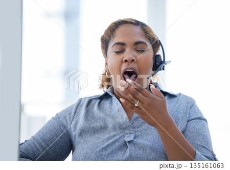 Call center, yawn and tired woman in office for telemarketing, crm or contact us, exhausted and sleepy. Burnout, yawning and female consultant suffering from fatigue while working in customer service 135161063