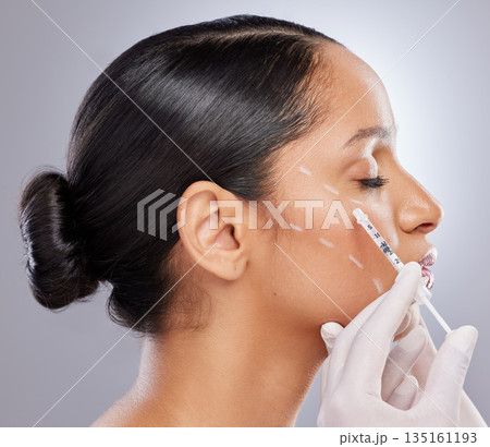 Face, filler and injection with woman in studio for plastic surgery, dermatology and beauty. Pattern, aesthetic and medical with model and syringe on grey background for collagen and cosmetics Face, filler and injection with woman in studio for plastic surgery, dermatology and beauty. Pattern, aesthetic and medical with model and syringe on grey background for collagen and cosmetics 135161193