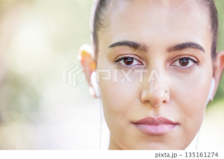 Face portrait, runner or woman with earphones for music to start training, workout or running exercise in park. Serious, healthy or sports girl athlete listening to radio or podcast about fitness Face portrait, runner or woman with earphones for music to start training, workout or running exercise in park. Serious, healthy or sports girl athlete listening to radio or podcast about fitness 135161274