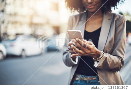 Woman, hands and phone in city for social media, communication or texting outdoors. Hand of business female chatting, online browsing or networking on mobile smartphone in street of an urban town 135161367