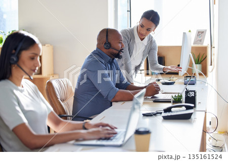 Call center, crm or support with a manager and consultant at work in an office for assistance. Contact us, customer service or consulting with hr management training an employee in telemarketing 135161524