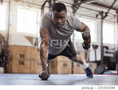 Dumbbells, push up and exercise with a black man at gym for fitness, training workout and strong muscle. Serious African athlete or bodybuilder person with weights for power, focus and performance Dumbbells, push up and exercise with a black man at gym for fitness, training workout and strong muscle. Serious African athlete or bodybuilder person with weights for power, focus and performance 135161589