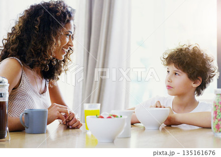 Family, breakfast and kid with mother at morning in a home with happiness and orange juice with care. Mom, food and young child together with love and support with healthy drink and youth with smile Family, breakfast and kid with mother at morning in a home with happiness and orange juice with care. Mom, food and young child together with love and support with healthy drink and youth with smile 135161676