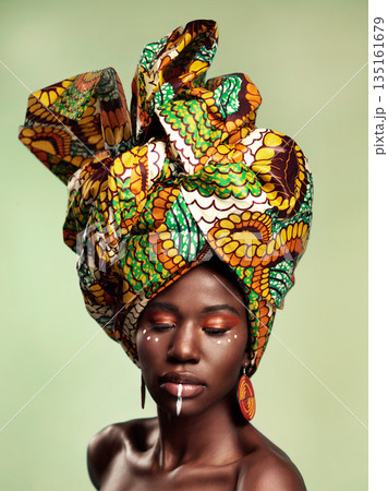 Beauty, black woman and queen makeup with African head wrap and pride with fashion. Isolated, green background and young female person with a traditional hair scarf with confidence and culture 135161679
