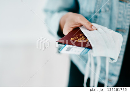 Covid, person and hands with passport, face mask and protection for boarding pass at airport. Closeup, travel and tourists journey of passenger with personal visa for safety, security or safeguarding Covid, person and hands with passport, face mask and protection for boarding pass at airport. Closeup, travel and tourists journey of passenger with personal visa for safety, security or safeguarding 135161786