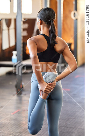 Gym, fitness or woman stretching leg to start workout or flexible body movement for wellness. Back veiw, active athlete or healthy girl in warm up for legs exercise training, flexibility or mobility Gym, fitness or woman stretching leg to start workout or flexible body movement for wellness. Back veiw, active athlete or healthy girl in warm up for legs exercise training, flexibility or mobility 135161799