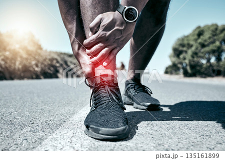Fitness, ankle and accident with a sports man holding his joint in pain while outdoor for a workout. Exercise, anatomy and injury with a male athlete feeling tender while training for recreation Fitness, ankle and accident with a sports man holding his joint in pain while outdoor for a workout. Exercise, anatomy and injury with a male athlete feeling tender while training for recreation 135161899