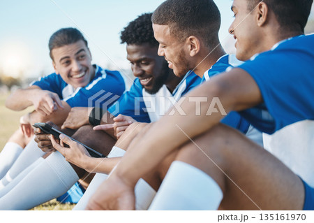 Group, tablet and soccer player team outdoor on field for fitness training or online game. Football, club and diversity athlete people or friends with tech to watch sports competition or funny video 135161970