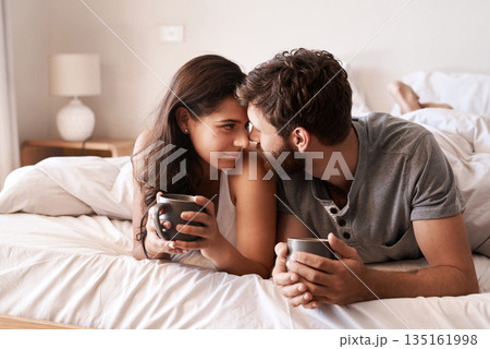 Home bedroom, coffee and couple bonding, relax and enjoy morning latte, espresso or beverage drinks. Forehead, marriage or romantic man, woman or people with tea cup, love and affection in hotel bed 135161998