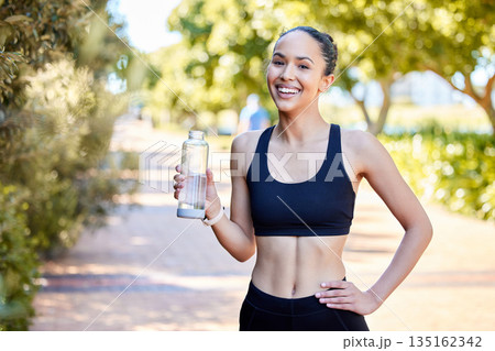 Happy woman, fitness and portrait with water bottle in rest after running, exercise or cardio workout in park. Fit, active and thirsty female person, athlete or runner with smile for sustainability Happy woman, fitness and portrait with water bottle in rest after running, exercise or cardio workout in park. Fit, active and thirsty female person, athlete or runner with smile for sustainability 135162342