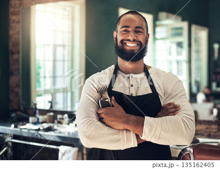Barber shop, hair stylist smile and black man portrait of an entrepreneur with beard trimmer. Salon, professional worker and male person face with happiness from small business and beauty parlor Barber shop, hair stylist smile and black man portrait of an entrepreneur with beard trimmer. Salon, professional worker and male person face with happiness from small business and beauty parlor 135162405