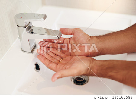 Tap, water and person cleaning hands for skincare, personal grooming and safety of bacteria, healthy and dermatology. Closeup, palm and washing hand at basin in bathroom for hygiene routine at home 135162583