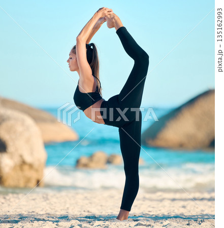 Woman, yoga and stretching legs on beach for exercise at the ocean, waves or nature Female athlete, stretch and focus on outdoor workout for peace, balance and healthy or holistic wellness practice 135162993