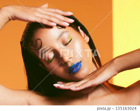Makeup, neon cosmetics and face of woman in studio for cosmetics, eye shadow and beauty salon. Creative aesthetic, cosmetology and female person with blue lipstick for glamour, luxury style and glow 135163024