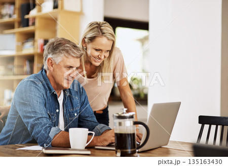 Happy couple, laptop and life insurance research at home with happiness and computer. Email, online banking and reading of a woman and man together in a house planning finance budget for retirement 135163430