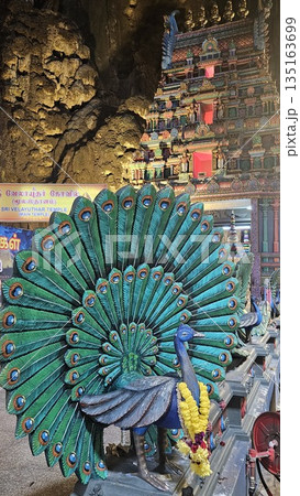 This is cave diorama features golden temples, ritual figures, and natural rock textures, blending Hindu symbolism in Batu Cave inside This is cave diorama features golden temples, ritual figures, and natural rock textures, blending Hindu symbolism in Batu Cave inside 135163699