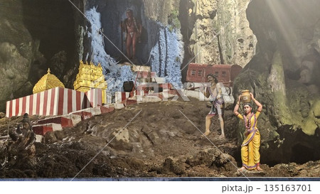 This is cave diorama features golden temples, ritual figures, and natural rock textures, blending Hindu symbolism in Batu Cave inside This is cave diorama features golden temples, ritual figures, and natural rock textures, blending Hindu symbolism in Batu Cave inside 135163701